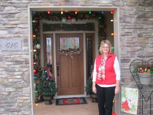 The font door sets the stage for everything.  I tend to like traditional themes, so i have used the old-school multi-colored lights with plaid ribbon, large ornaments and garland.  The flag and arrangement made from greenery and pine cones provide an additional welcome.