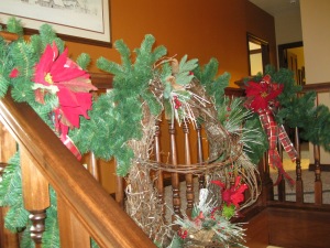 A grapevine wreath with cardinal accents hangs from the upper level.  