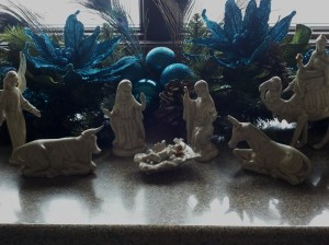 A nativity scene and more peacock decor decorate the mantel in the master bedroom.  